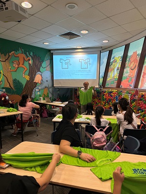 Participants learning how to upcycle t-shirts into tote bags and create enzyme cleaner